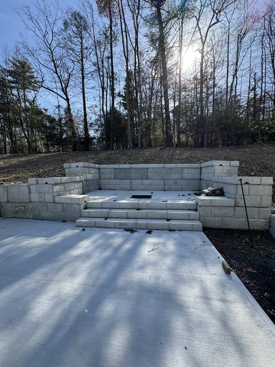 Concrete block seating wall and steps built around a fire pit area